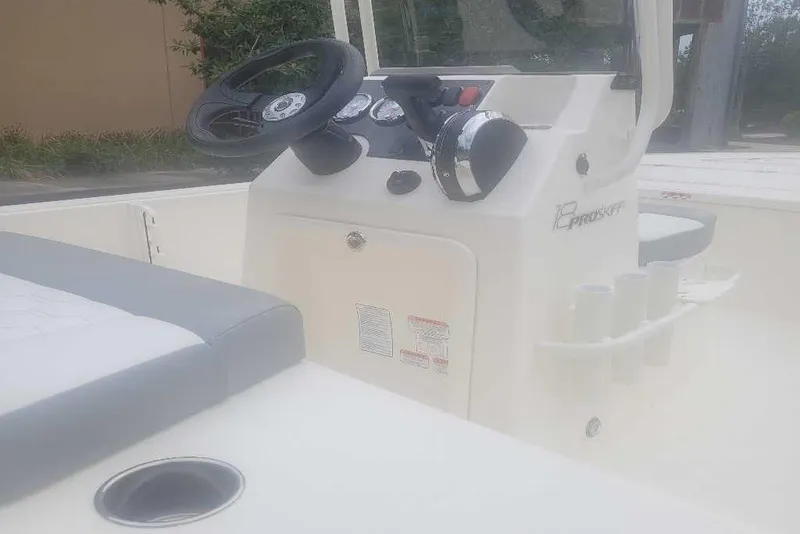Slide: The Image of 2026 Mako 18 Pro Skiff boat interior with steering console and seating. - 6