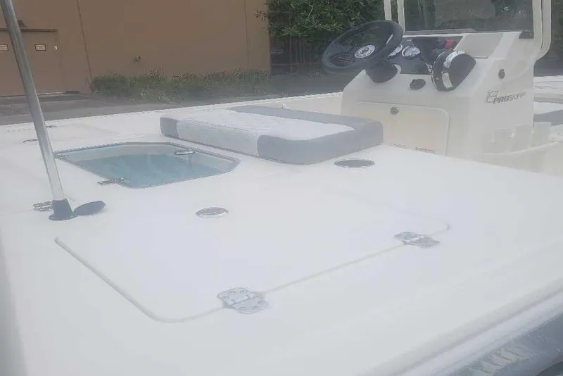 Slide: The Image of 2026 Mako 18 Pro Skiff boat interior with steering console and seating. - 7