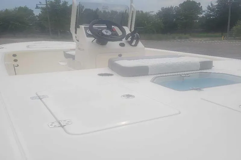 Slide: The Image of 2026 Mako 18 Pro Skiff boat interior with steering console and seating area. - 8