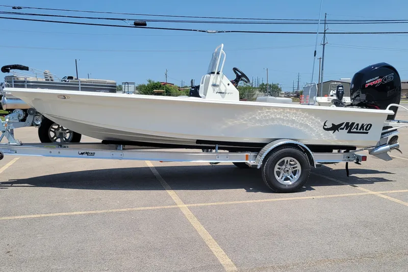 The Image of 2026 Mako 18 Pro Skiff boat on trailer in parking lot, side view. - 0