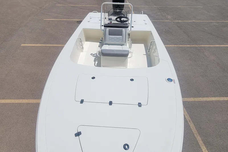 Slide: The Image of 2026 Mako 18 Pro Skiff boat, top view, parked on asphalt. - 2