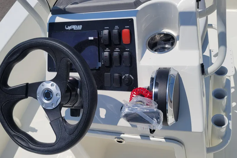 Slide: The Image of 2026 Mako 18 Pro Skiff boat console with steering wheel and control panel. - 3