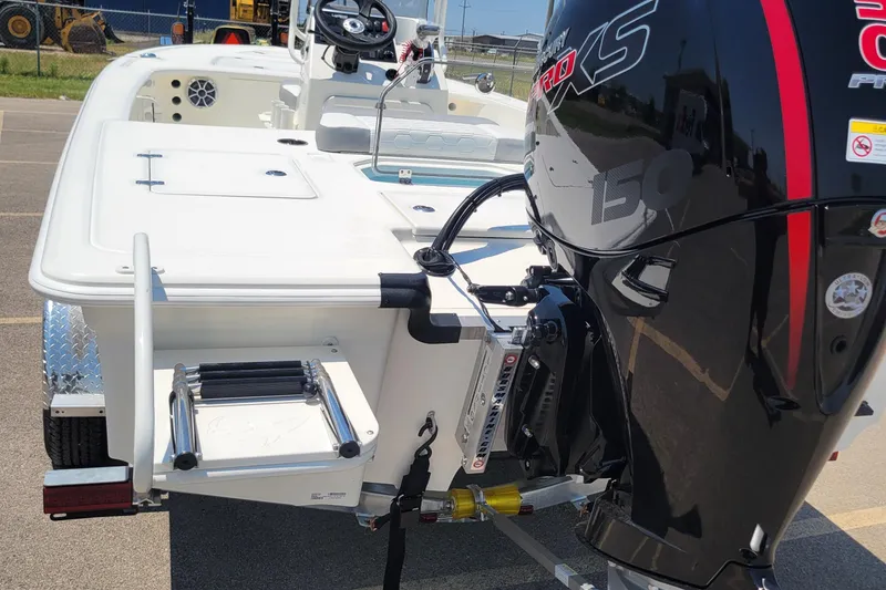 Slide: The Image of 2026 Mako 18 Pro Skiff with powerful outboard motor and rear ladder. - 4