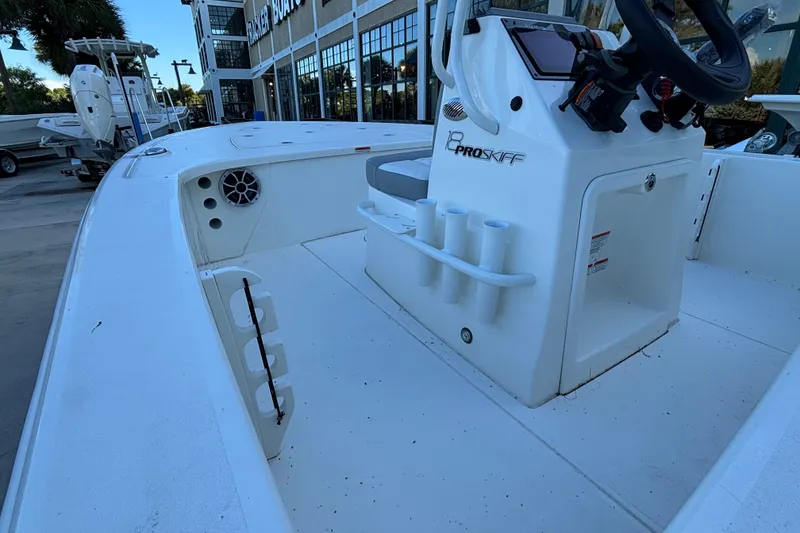 Slide: The Image of 2026 Mako 18 Pro Skiff boat interior with steering console and rod holders. - 4