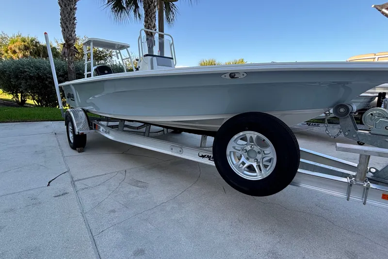 The Image of 2026 Mako 18 Pro Skiff boat on trailer, parked outdoors under clear sky. - 0