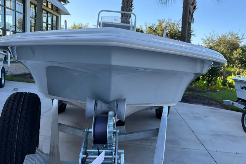 Slide: The Image of 2026 Mako 18 Pro Skiff boat on trailer, displayed outdoors. - 1