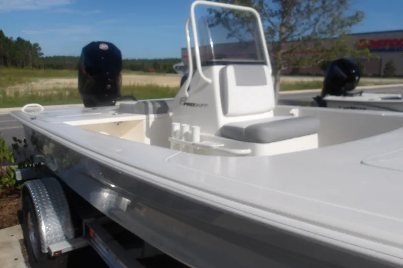 Slide: The Image of 2026 Mako 18 Pro Skiff boat with sleek design, parked outdoors on a trailer. - 17