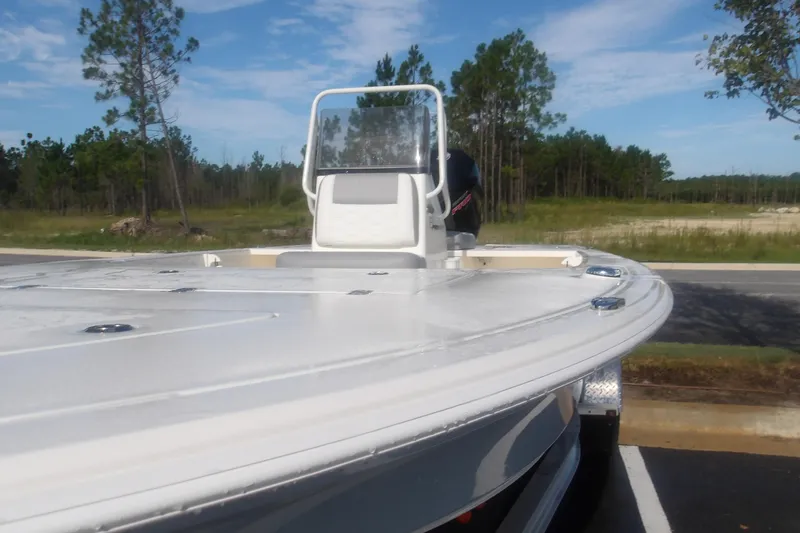 Slide: The Image of 2026 Mako 18 Pro Skiff boat parked outdoors, showcasing sleek design and console. - 5