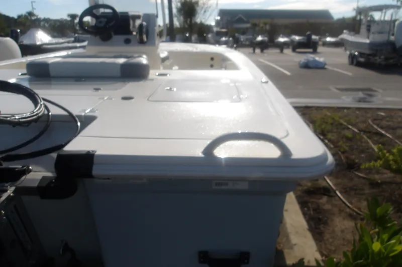 Slide: The Image of 2026 Mako 18 Pro Skiff boat in parking lot, showcasing deck and steering console. - 11