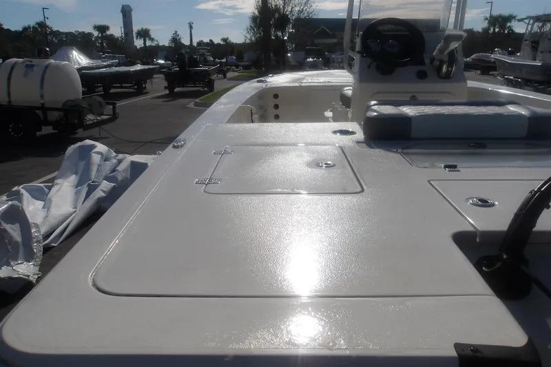 Slide: The Image of 2026 Mako 18 Pro Skiff boat deck in a sunny outdoor setting. - 12