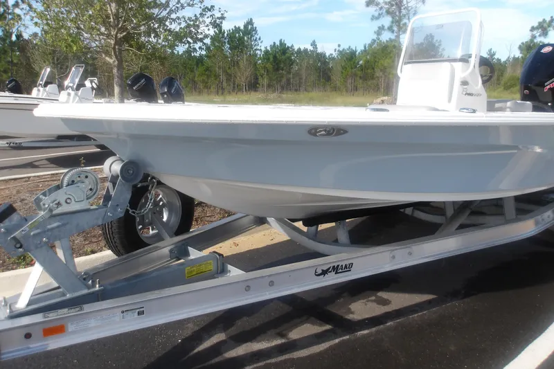 Slide: The Image of 2026 Mako 18 Pro Skiff boat on trailer, parked outdoors, ready for adventure. - 4