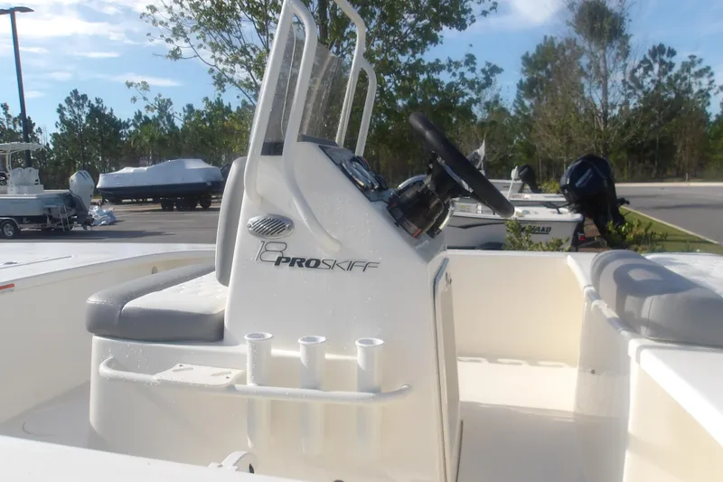 Slide: The Image of 2026 Mako 18 Pro Skiff boat interior with steering console and seating. - 6