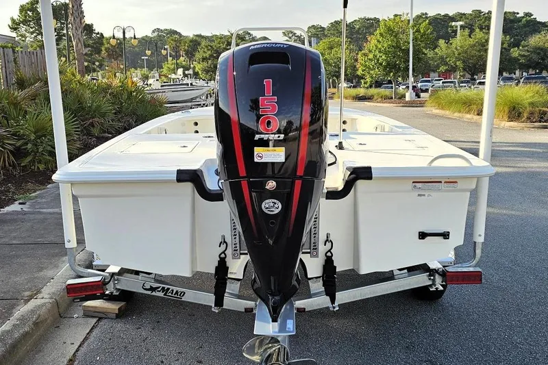Slide: The Image of 2026 Mako 18 Pro Skiff with 150 HP Mercury outboard engine, parked on a trailer. - 5