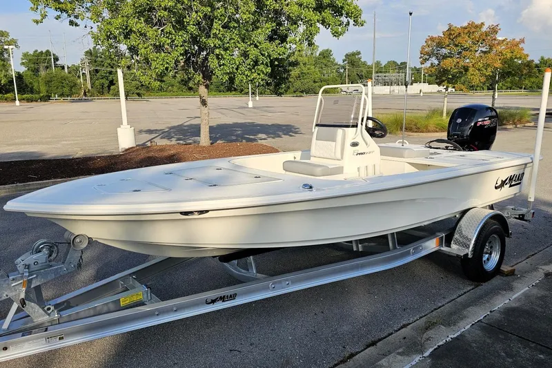Slide: The Image of 2026 Mako 18 Pro Skiff boat on trailer in parking lot, sunny day. - 7