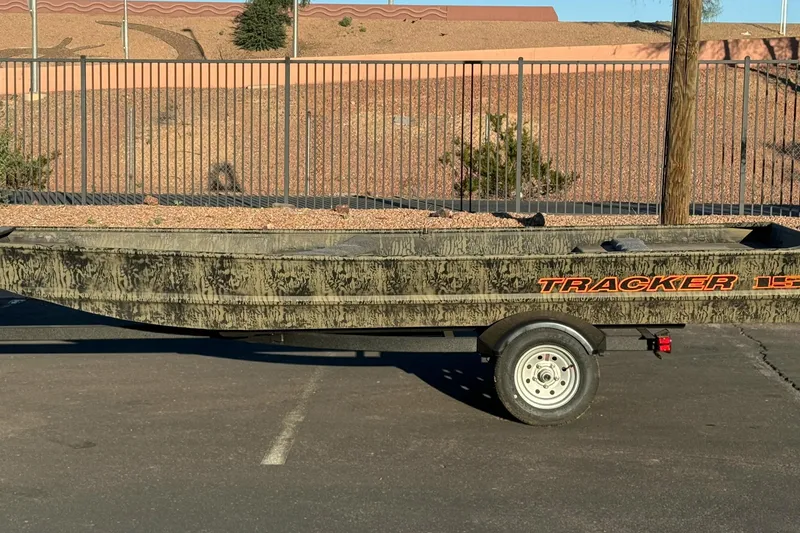 The Image of 2026 Tracker Grizzly 15 Jon boat on trailer in parking lot. - 0
