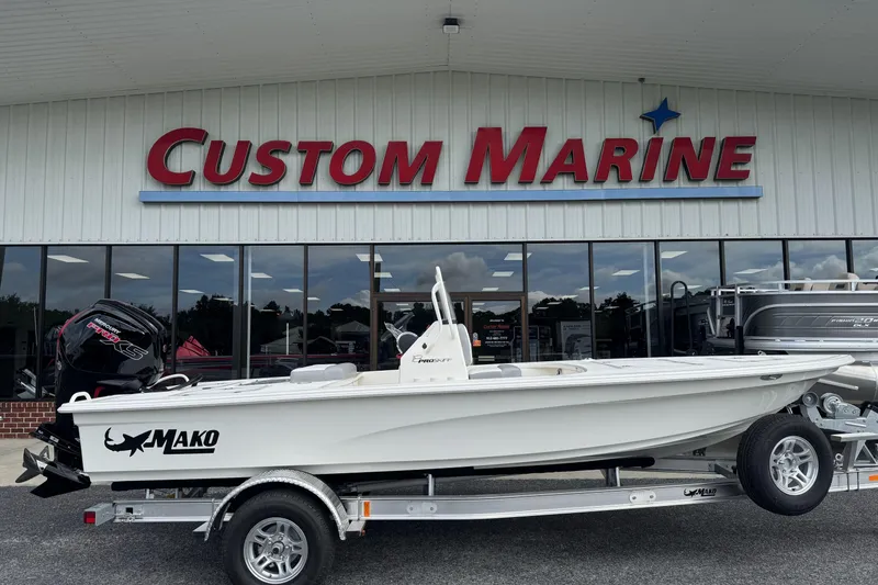 The Image of 2026 Mako 18 Pro Skiff boat on trailer outside Custom Marine store. - 0