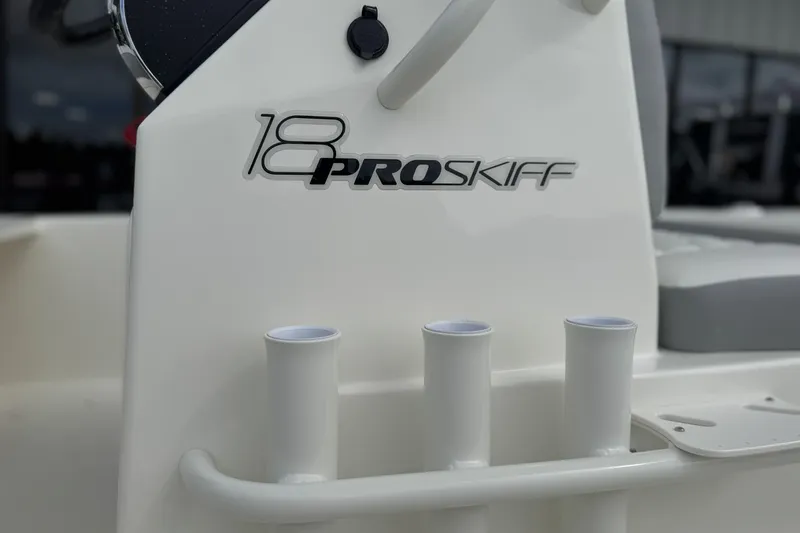 Slide: The Image of 2026 Mako 18 Pro Skiff boat console with rod holders and logo detail. - 11