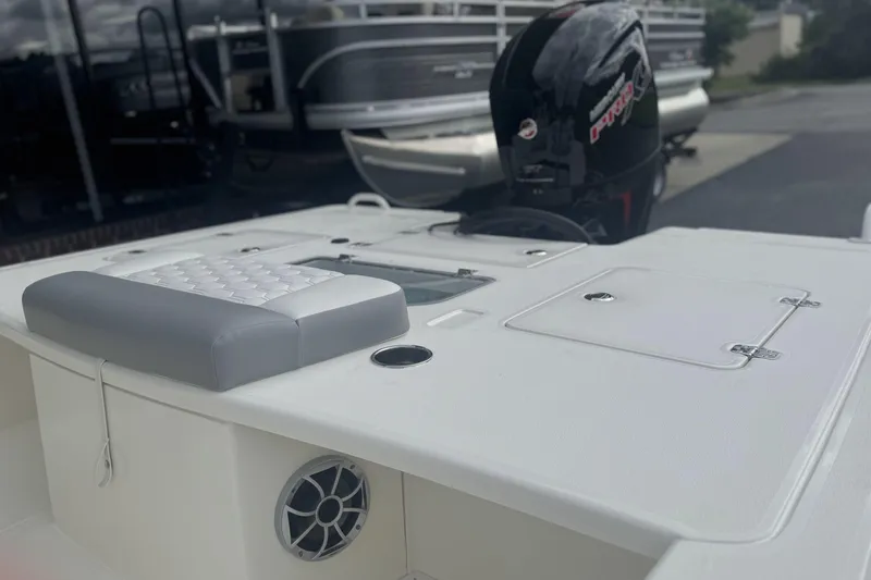 Slide: The Image of 2026 Mako 18 Pro Skiff boat with cushioned seating and outboard motor. - 13