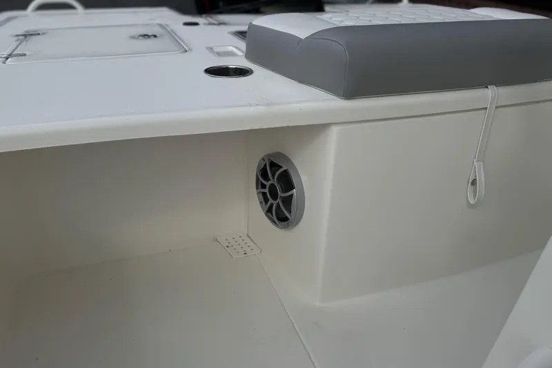 Slide: The Image of 2026 Mako 18 Pro Skiff interior detail with speaker and cushioned seat. - 15