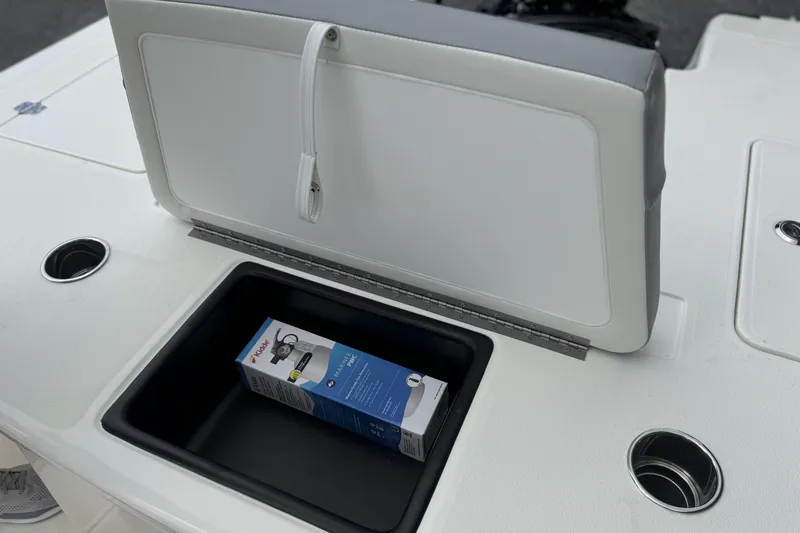 Slide: The Image of Open storage compartment on 2026 Mako 18 Pro Skiff boat with a box inside. - 28