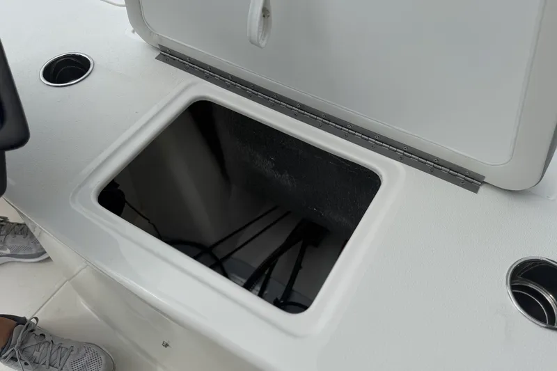 Slide: The Image of Open storage compartment on 2026 Mako 18 Pro Skiff boat deck. - 29
