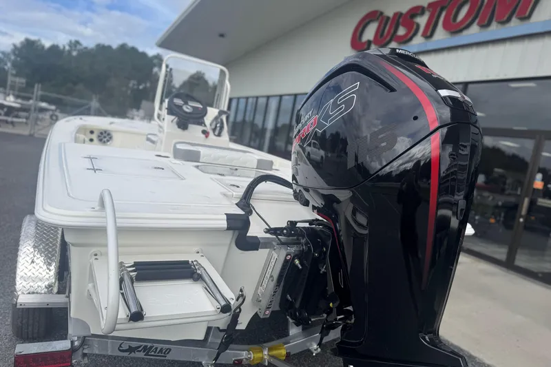 Slide: The Image of 2026 Mako 18 Pro Skiff with powerful outboard motor at dealership. - 3