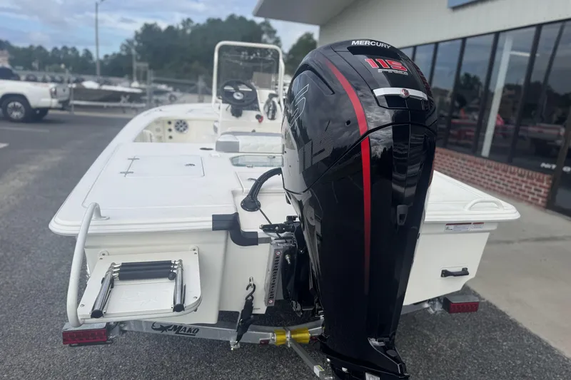 Slide: The Image of 2026 Mako 18 Pro Skiff with Mercury 115 outboard motor, parked outdoors. - 4