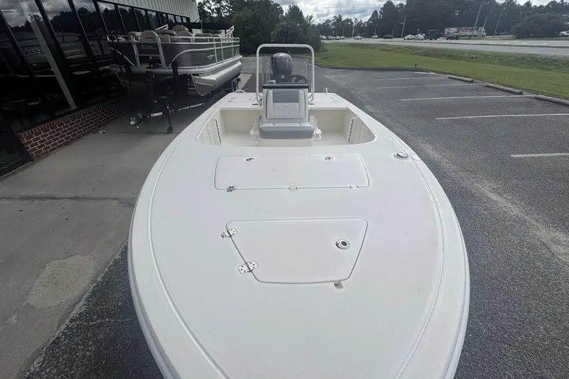 Slide: The Image of 2026 Mako 18 Pro Skiff boat displayed in a parking lot, showcasing its sleek design. - 8