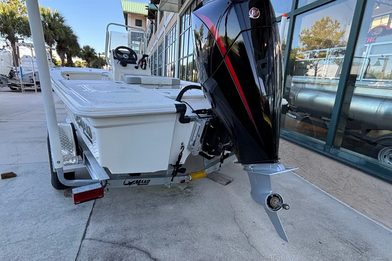 Slide: The Image of 2026 Mako 18 Pro Skiff boat on trailer, featuring a powerful outboard motor. - 2