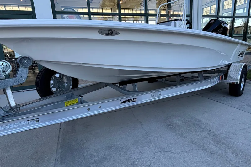 Slide: The Image of 2026 Mako 18 Pro Skiff boat on trailer, displayed outdoors. - 1