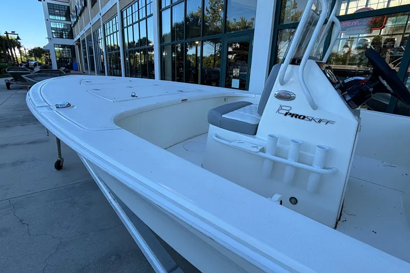 Slide: The Image of 2026 Mako 18 Pro Skiff boat displayed outdoors near a modern building. - 3