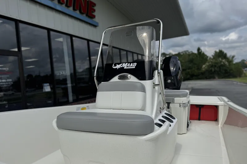 Slide: The Image of 2026 Mako Pro Skiff 15 CC boat with console and seating, displayed outdoors. - 11