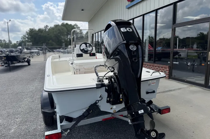 Slide: The Image of 2026 Mako Pro Skiff 15 CC boat with Mercury 60 engine on trailer. - 3