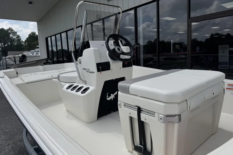 Slide: The Image of 2026 Mako Pro Skiff 15 CC boat with console and seating, displayed outdoors. - 5
