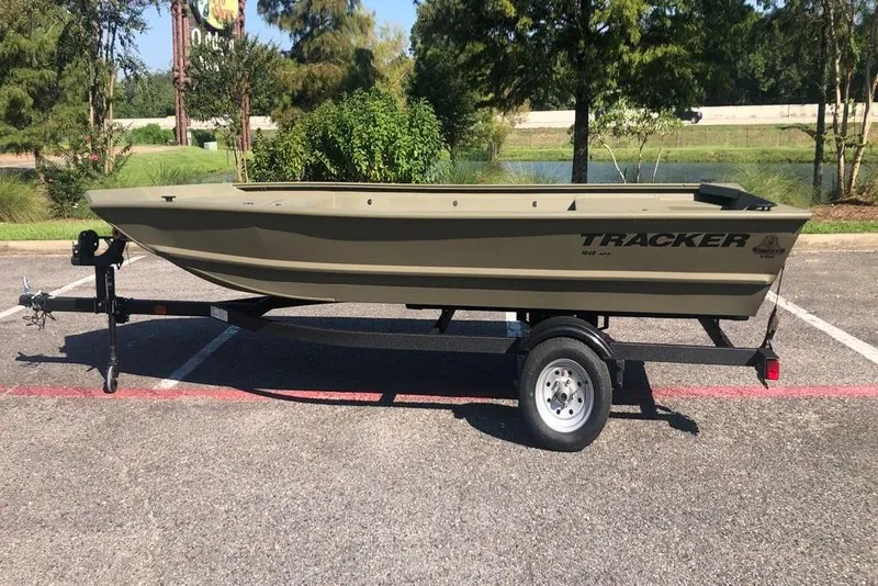 The Image of 2026 Tracker Grizzly 1648 Utility boat on trailer in parking lot. - 0