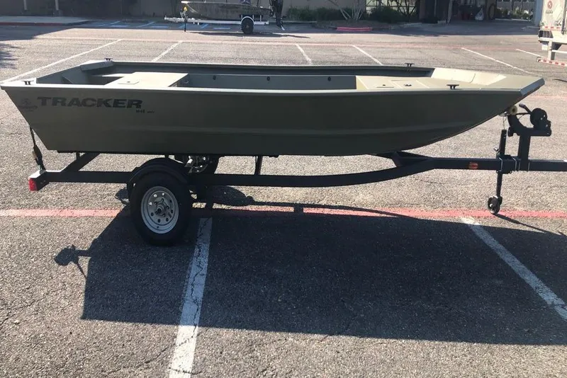 Slide: The Image of 2026 Tracker Grizzly 1648 Utility boat on trailer in parking lot. - 3