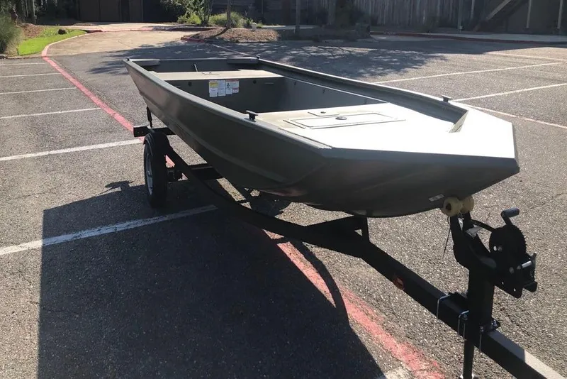 Slide: The Image of 2026 Tracker Grizzly 1648 Utility boat on trailer in parking lot. - 4