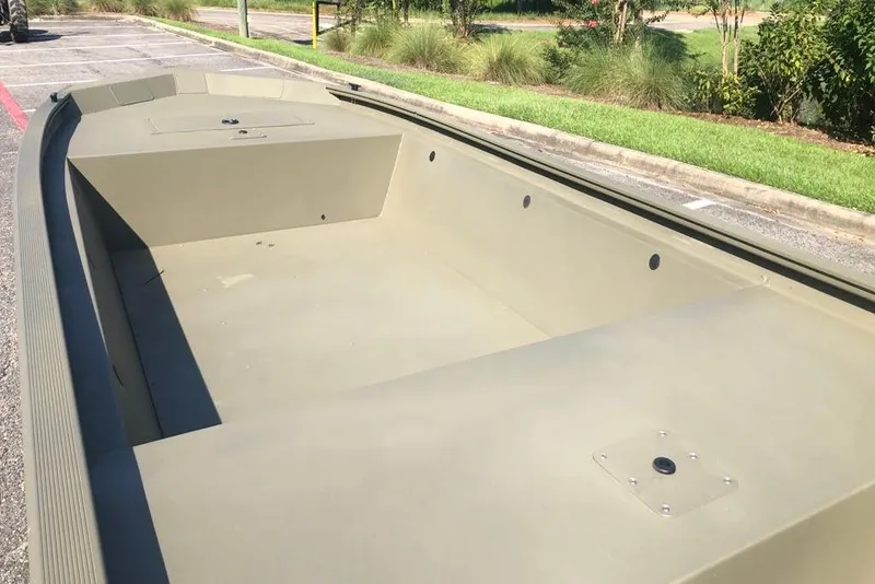 Slide: The Image of 2026 Tracker Grizzly 1648 Utility boat, spacious interior, parked outdoors. - 8