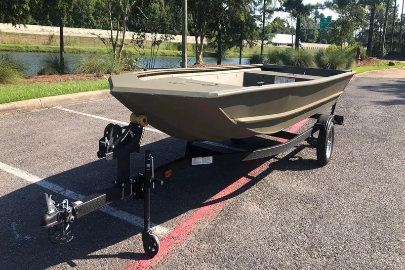 Slide: The Image of 2026 Tracker Grizzly 1648 Utility boat on trailer in parking lot. - 9