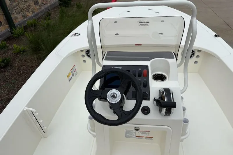 Slide: The Image of 2026 Mako 18 Pro Skiff boat console with steering wheel and controls. - 59