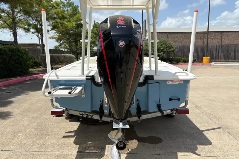 Slide: The Image of 2026 Mako 18 Pro Skiff with powerful outboard motor, parked outdoors. - 8