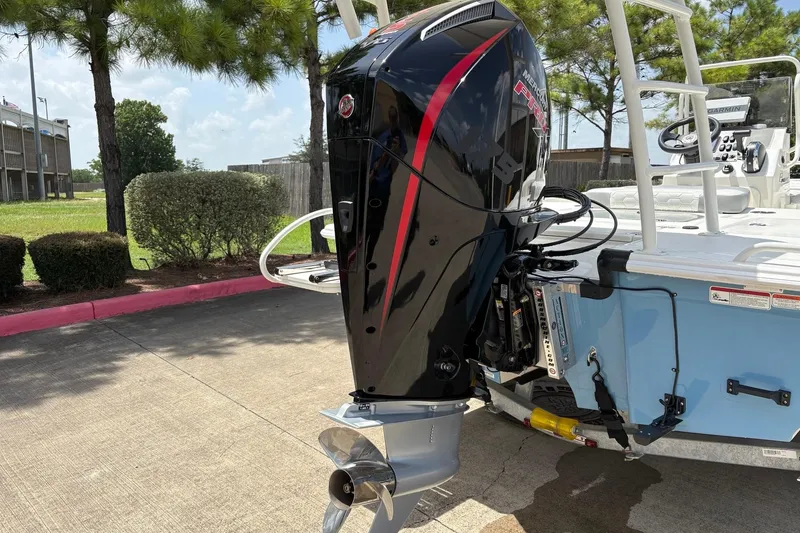Slide: The Image of 2026 Mako 18 Pro Skiff with powerful outboard motor, parked outdoors. - 7