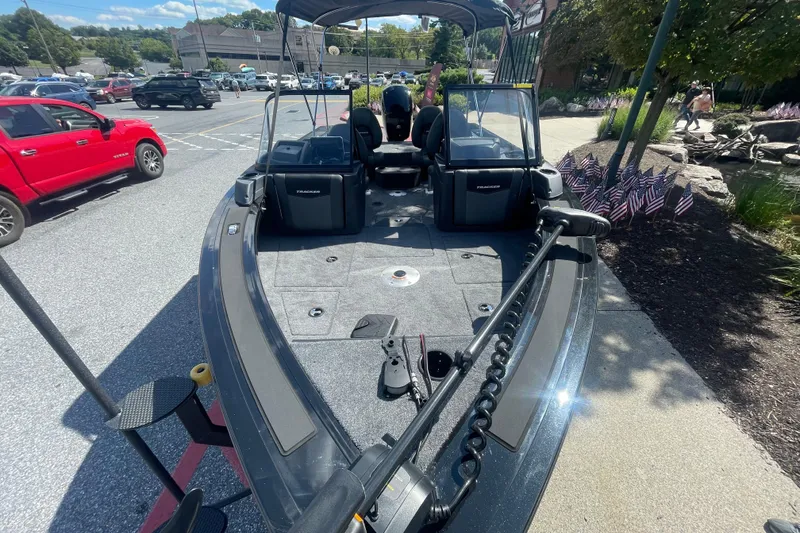 Slide: The Image of 2026 Tracker Targa V-19 WT boat parked outdoors, showcasing spacious interior and modern design. - 2