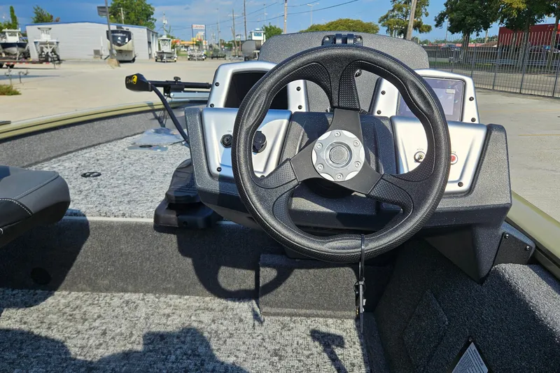 Slide: The Image of 2026 Tracker Pro Team 175 Crappie Edition boat interior with steering wheel and dashboard. - 10