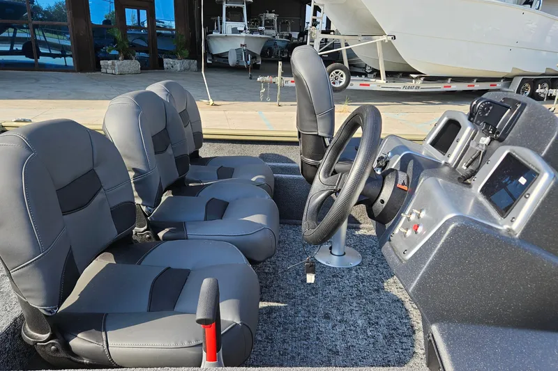 Slide: The Image of 2026 Tracker Pro Team 175 Crappie Edition boat interior with seating and steering console. - 11
