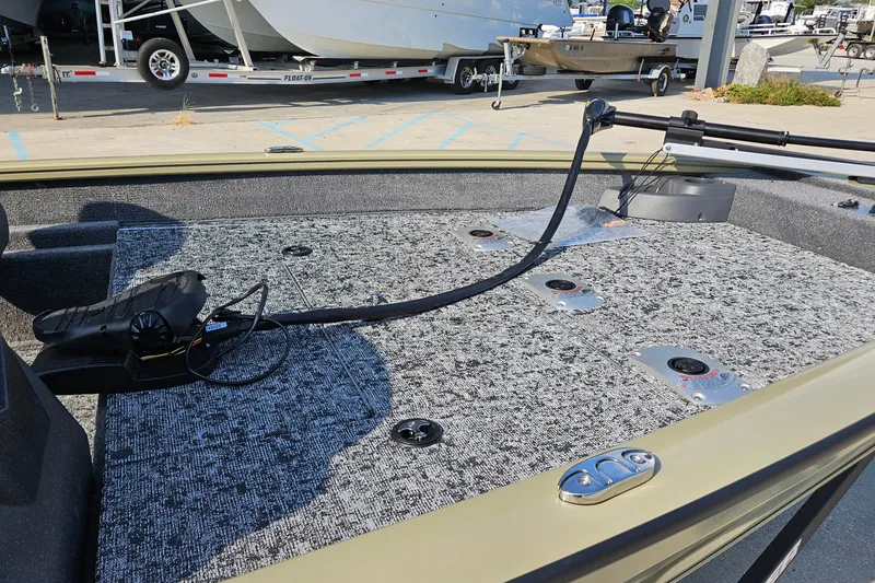 Slide: The Image of 2026 Tracker Pro Team 175 Crappie Edition boat deck with fishing rod holders. - 12