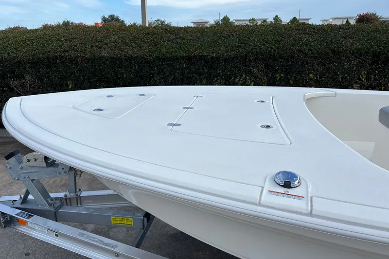 Slide: The Image of 2026 Mako 18 Pro Skiff boat on trailer, showcasing sleek white deck design. - 9
