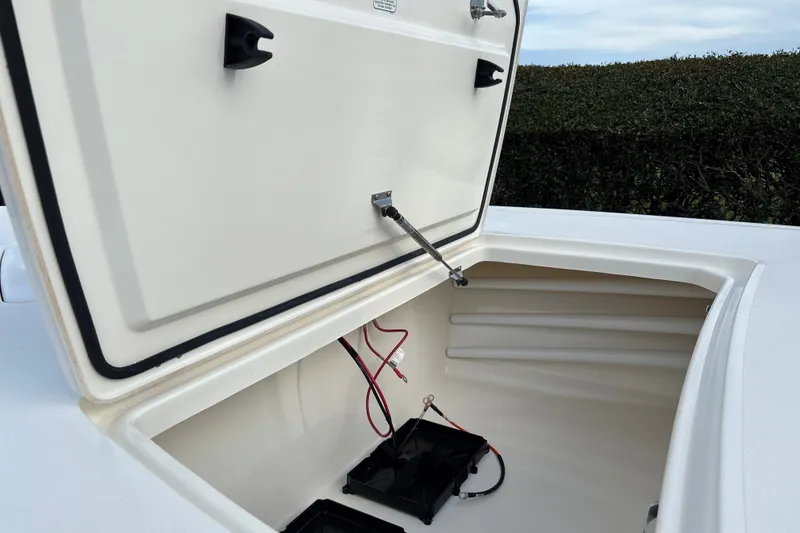 Slide: The Image of Open storage compartment of 2026 Mako 18 Pro Skiff boat, showing interior wiring. - 17