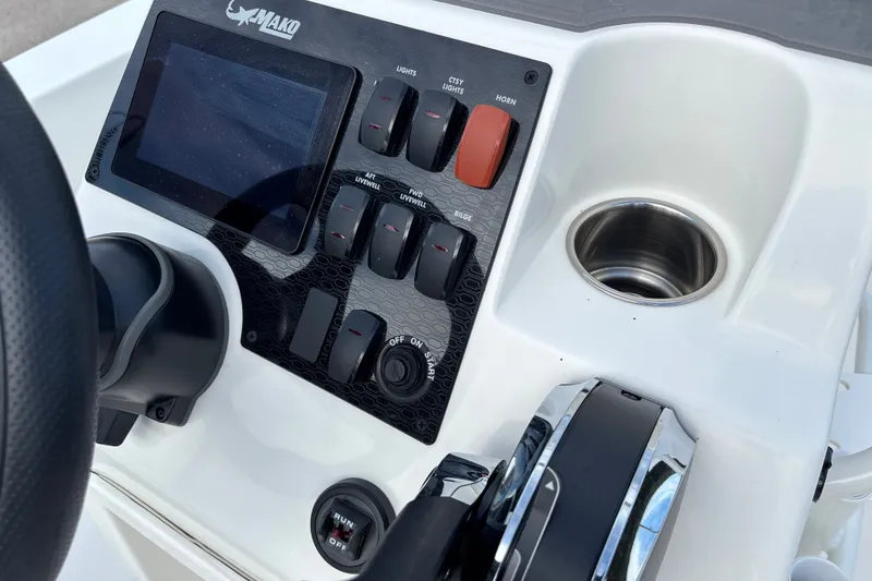 Slide: The Image of Control panel of 2026 Mako 18 Pro Skiff boat with switches and cup holder. - 13