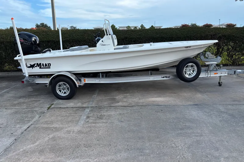 Slide: The Image of 2026 Mako 18 Pro Skiff boat on trailer, parked outdoors. - 4